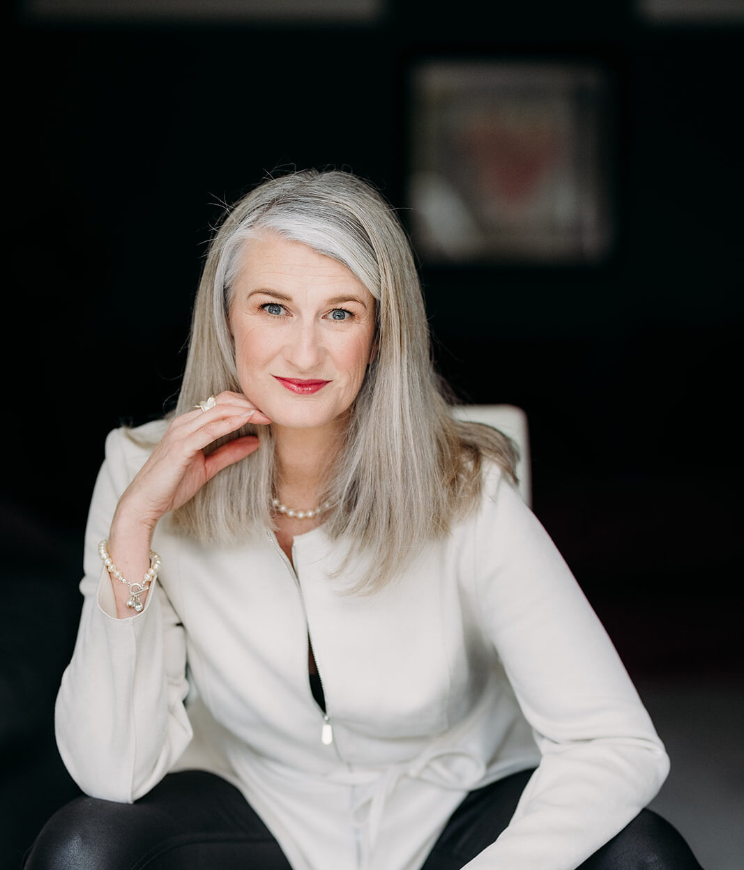 Nicky sitting with right hand under her chin